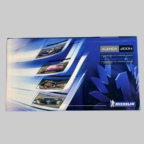 Agenda Michelin 2004 vintage neuf, vue de la couverture illustrée consacrée aux Championnats du Monde des Rallyes et de Moto.