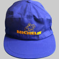 Casquette vintage Michelin bleue avec Bibendum et logo Michelin brodés en jaune. Ancien objet publicitaire de collection en très bel état.