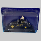 Miniature Peugeot 202 Michelin de collection présentée dans son boîtier transparent de protection, vue de trois quarts du véhicule.
