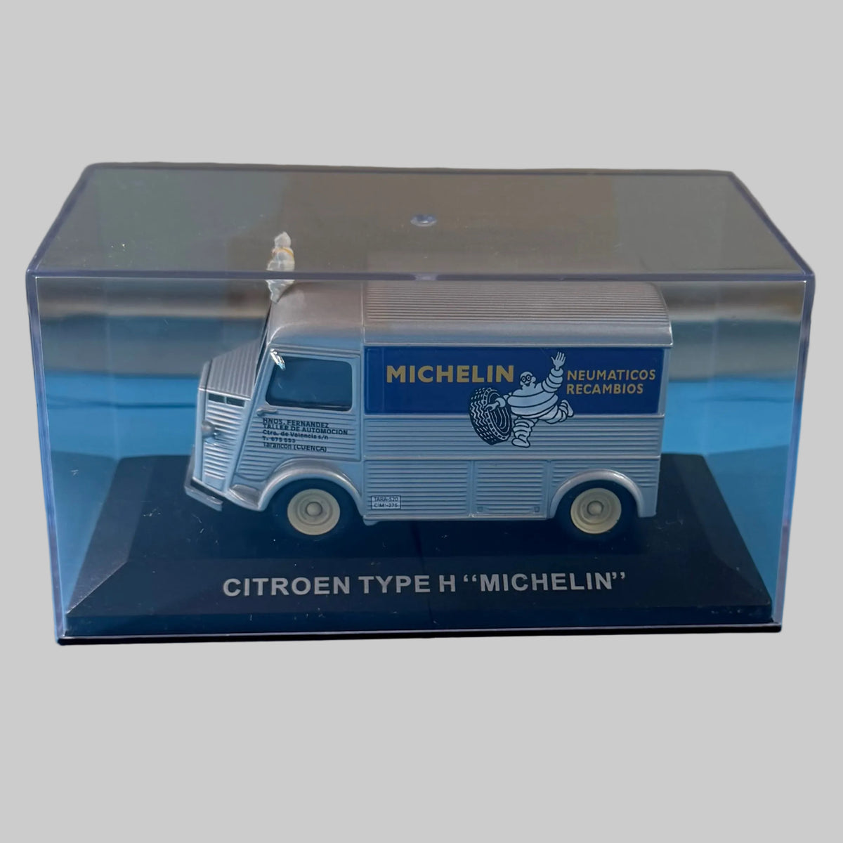 Miniature Citroën Type H Michelin gris métallisé et bleu, collection espagnole, présentée dans sa vitrine transparente sur socle noir.