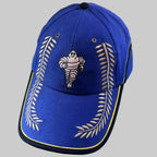 Casquette Michelin Podium bleue neuve avec Bibendum et grands lauriers dorés brodés sur la face avant et la visière.