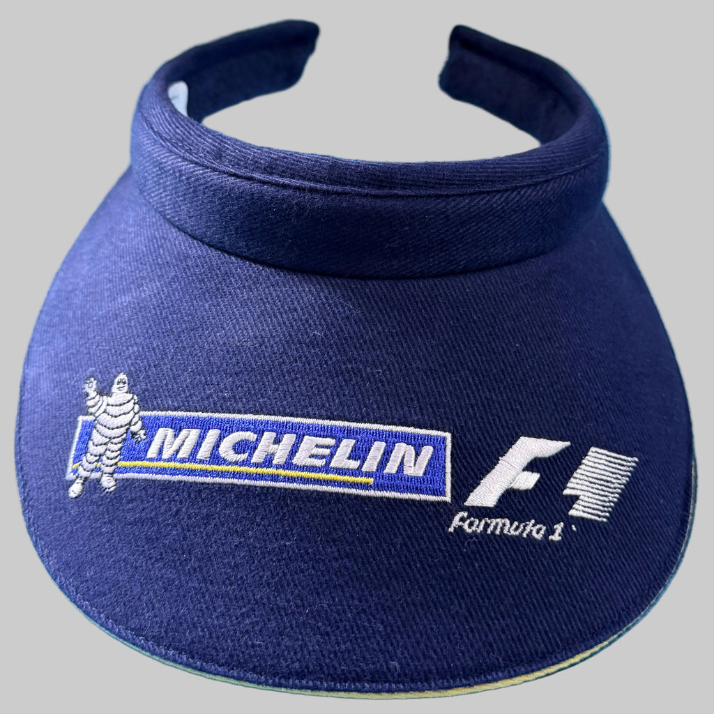 Visière Michelin Formula 1 bleu marine avec broderies Bibendum, Michelin et logo F1 vintage.
